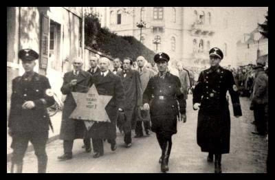 Jews_forced_to_march_with_star_Kristallnacht